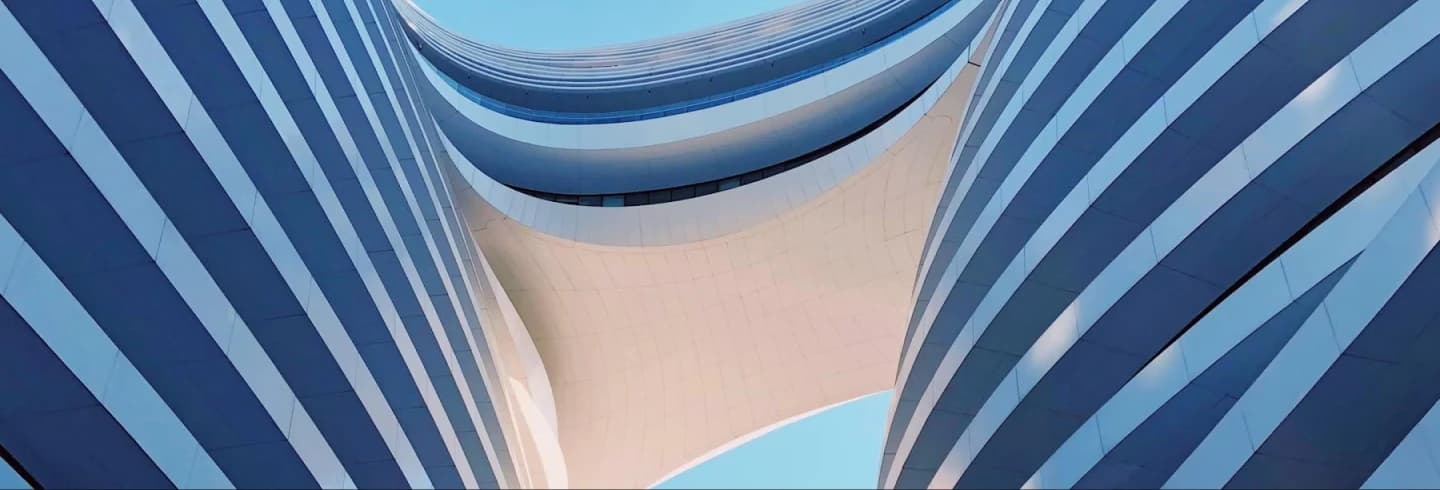 Looking up through a curved modern building facade